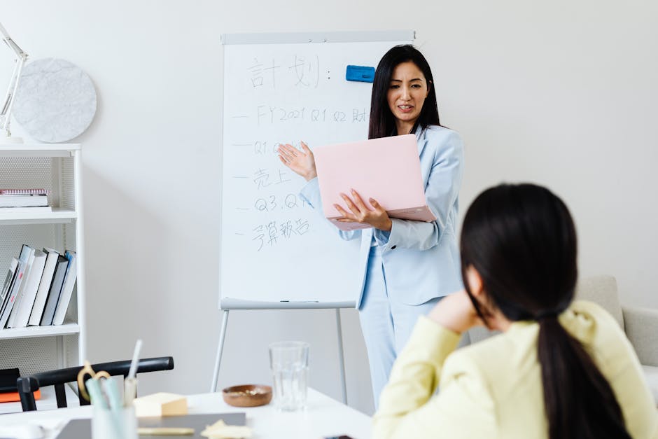 Professional woman presenting financial results to a colleague in a modern office.